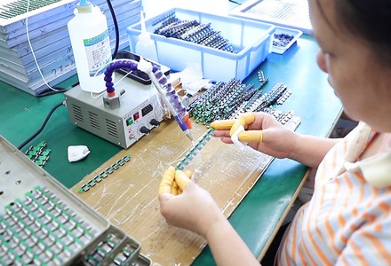 Operator preparing connector terminals on a fixture at the bench