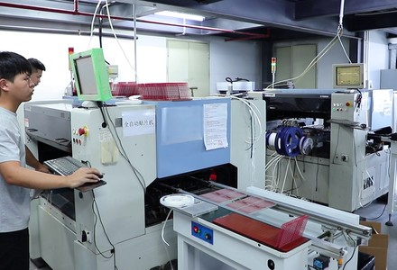 Automatic pick and place machine mounting components on connector boards