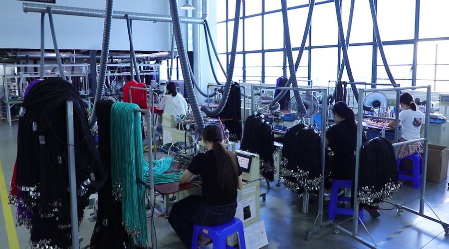 Cable assembly and in-process test area with cut cable bundles hanging at the benches