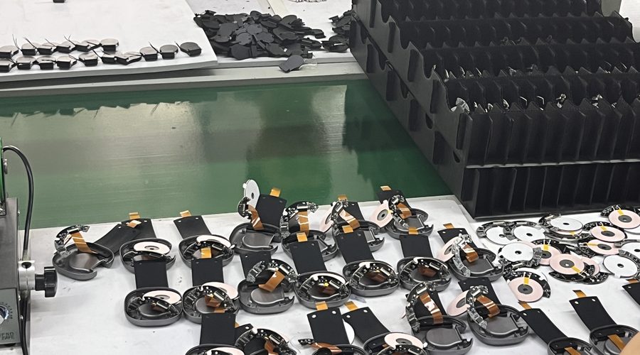 Coil, ferrite and flexible printed circuit subassemblies laid out at the coil-to-board station